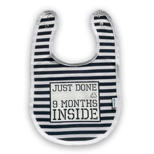 Load image into Gallery viewer, Black and white stripy bib featuring Just Done 9 Months Inside slogan